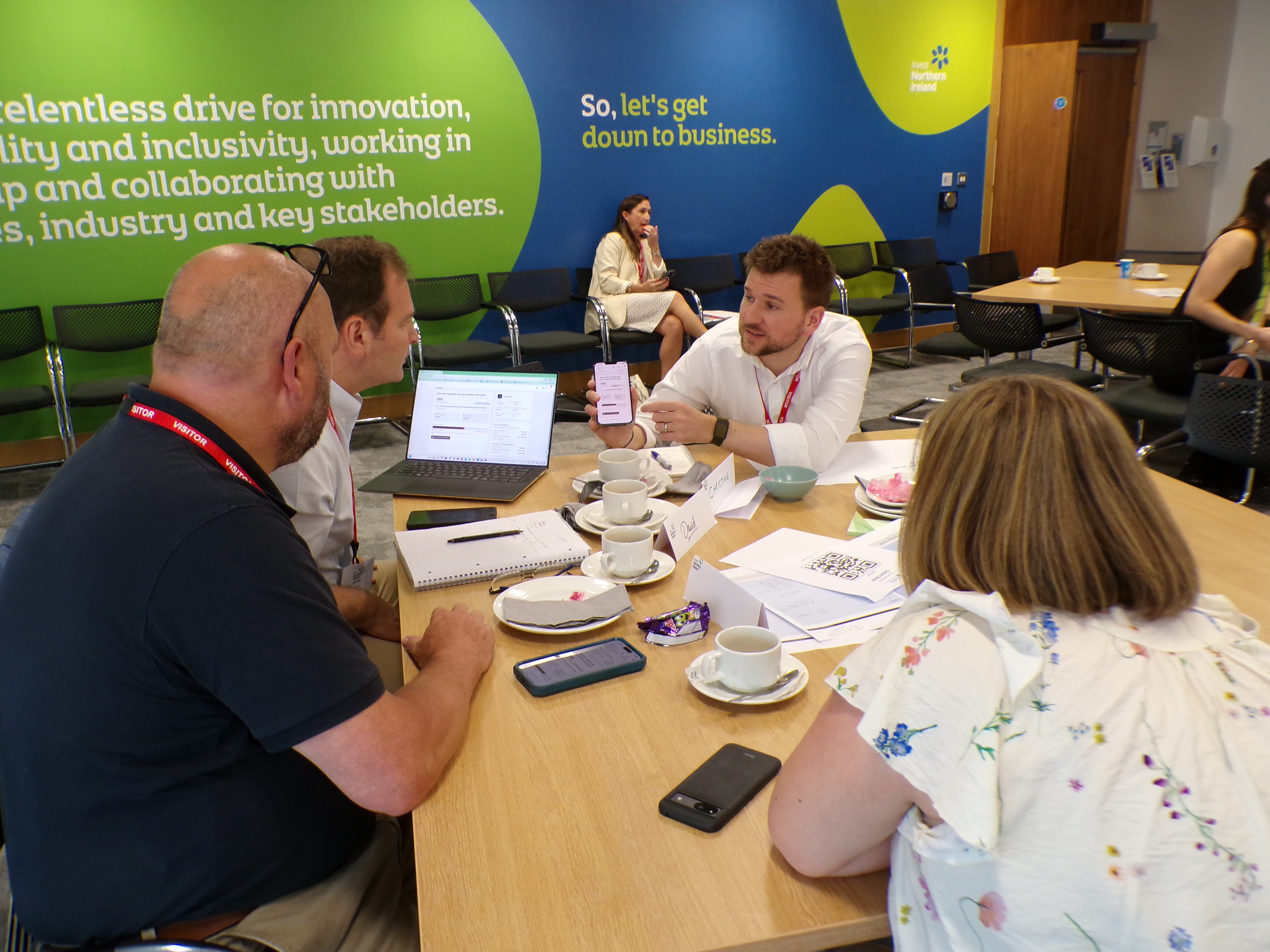 A participant pointing at the simulation user interface on their phone