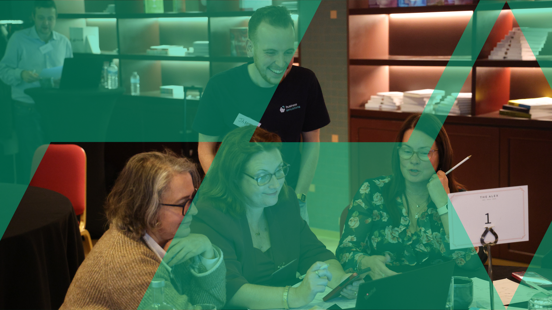 Team of colleagues collaborating around a laptop with a Business Simulations facilitator, under a green brand-motif overlay