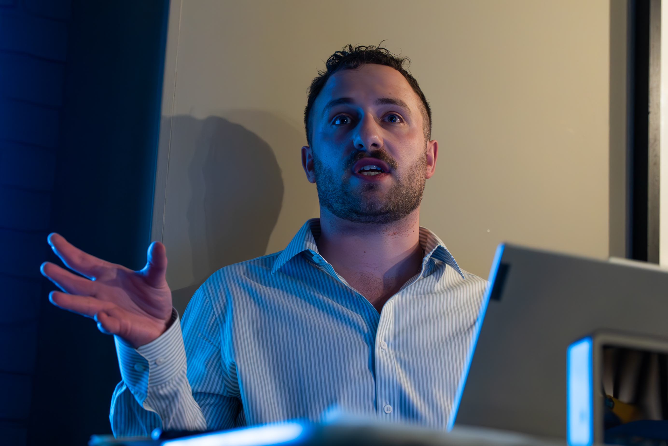 Facilitator speaking and gesturing expressively during a business simulation session