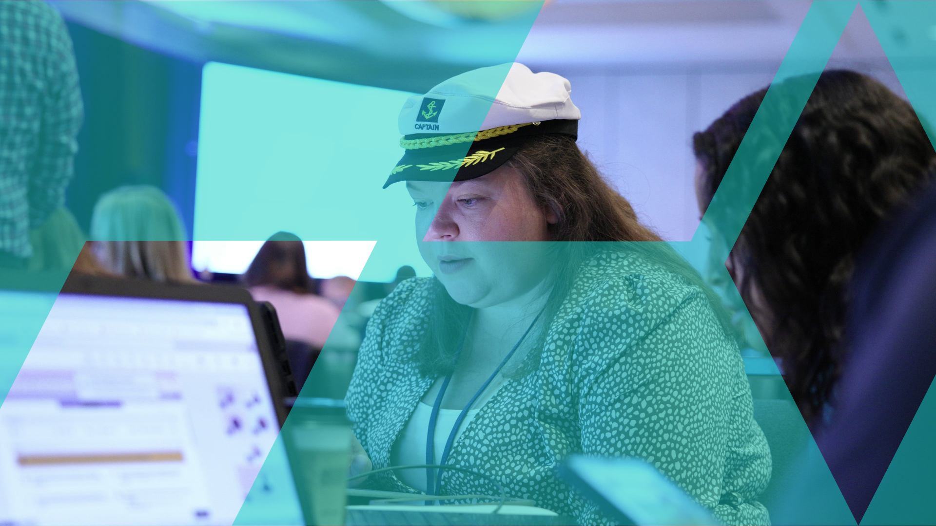 A participant wearing a captain's hat concentrating during a cruise ship business simulation.
