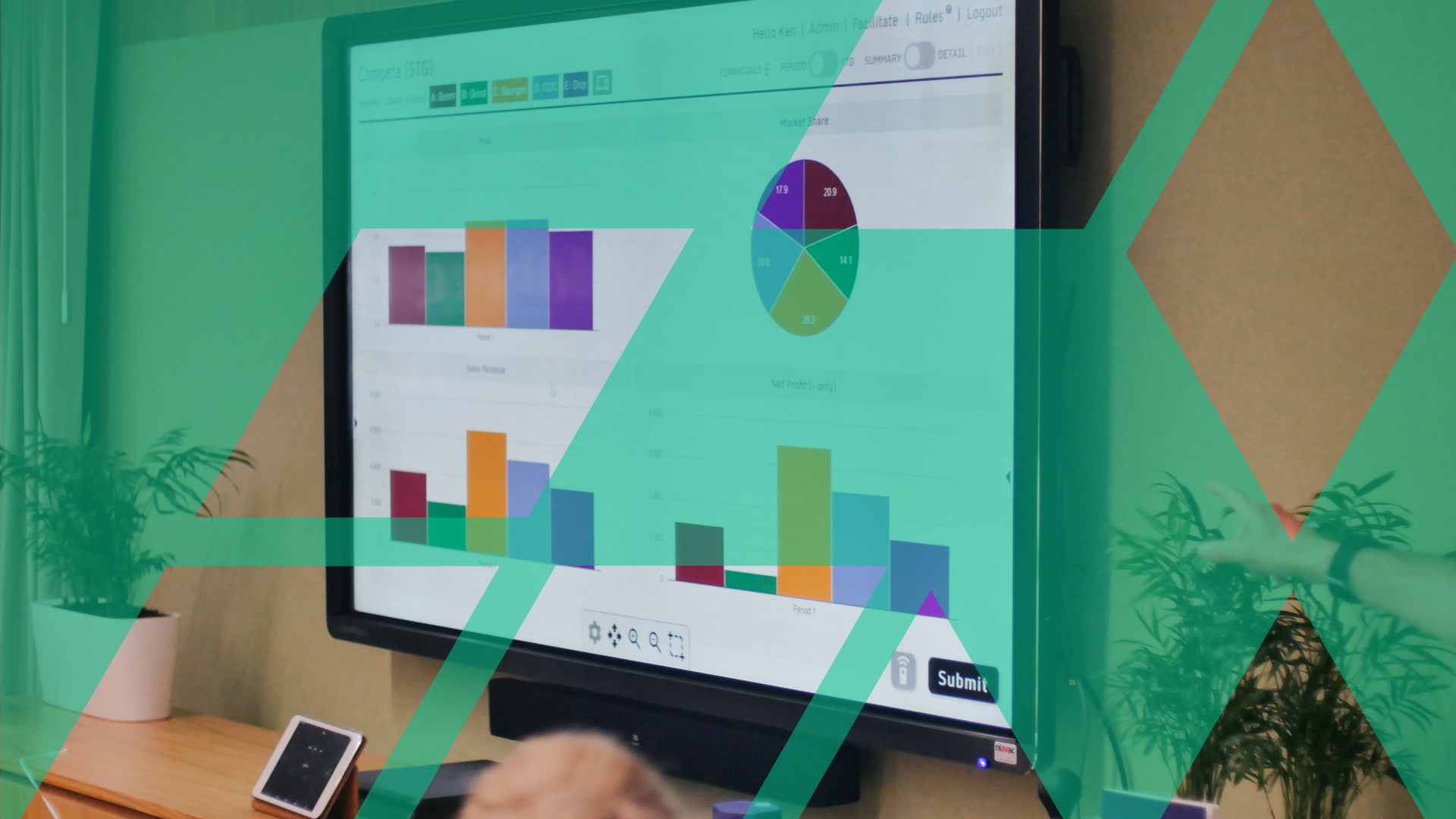 A wall-mounted screen displaying simulation results as bar and pie charts during a session in a wood-panelled room.